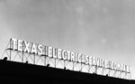 The Texas Electric Company's neon sign is lit against the evening sky in Fort Worth by W. D. Smith