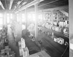 Interior of warehouse with aisles of stock by W. D. Smith