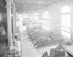 Interior of warehouse with aisles of stock by W. D. Smith