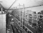 Interior of warehouse with aisles of stock by W. D. Smith