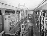 Interior of warehouse with aisles of stock by W. D. Smith