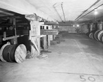 Interior of warehouse with aisles of stock by W. D. Smith