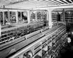 Interior of warehouse with aisles of stock by W. D. Smith