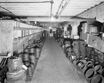 Interior of warehouse with aisles of stock by W. D. Smith