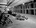 Interior of warehouse with aisles of stock by W. D. Smith