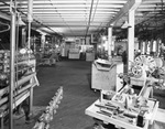 Interior of warehouse with aisles of stock by W. D. Smith