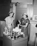 Women standing by prize display by W. D. Smith