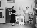 Women standing by Drumstick icebox by W. D. Smith