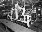 General Motors Plant employee working on car by W. D. Smith