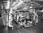 General Motors plant employees working on car by W. D. Smith