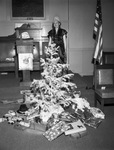 Photograph of Ladies Oriental Shrine of North America High Priestess Laura Smith with christmas tree by W. D. Smith