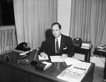 Photograph of Charles Ringler sitting at desk by W. D. Smith