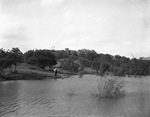 Man standing by lake by W. D. Smith