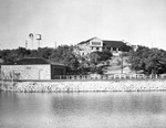 House on hill overlooking water by W. D. Smith