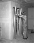 Ready Hung Doors--Man installing door by W. D. Smith