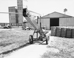 Farm elevator and equipment outside the Traders Cotton Oil Mill Co. plant by W. D. Smith