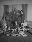 Family portrait around Christmas tree by W. D. Smith