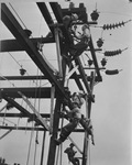 Men working on utility tower by W. D. Smith