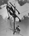 Men working on utility tower by W. D. Smith