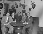 Group sitting around table by W. D. Smith