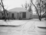 Exterior view of home with car garage by W. D. Smith