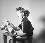 Woman posing in photography studio by W. D. Smith