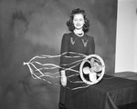 Woman with fan in studio by W. D. Smith