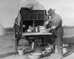 Man cooking at a chuck wagon by W. D. Smith