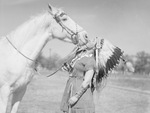 Woman in Native American dress with horse by W. D. Smith