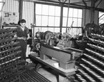 Shop worker holding metal product by W. D. Smith