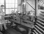 Shop worker holding metal product by W. D. Smith