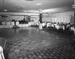 A banquet room with a wooden dance floor surrounded by carpet by W. D. Smith