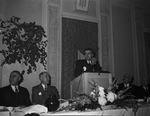 A man stands at a podium by W. D. Smith