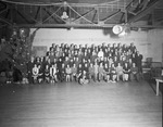 Group portrait of employees beside Christmas tree by W. D. Smith