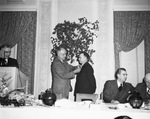 Mr. Frion receiving a lapel pen at a ceremony by W. D. Smith