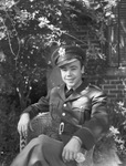 Young man in military uniform sitting in chair by W. D. Smith