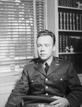 Young man in military uniform sitting in chair by W. D. Smith