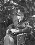 Young man in military uniform sitting in chair by W. D. Smith