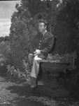 Young man in military uniform in a garden by W. D. Smith