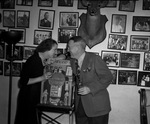 Man and woman leaning against a slot machine by W. D. Smith