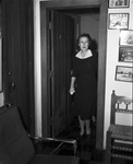 Woman standing in doorway by W. D. Smith