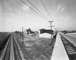 Industrial Plant as viewed from the intersection of railroad tracks and street by W. D. Smith