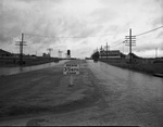 Road with speed limit sign and billboards by W. D. Smith