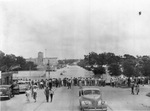 People lining street at water's edge during flood