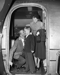 Young boy with parents (?) at airport by W. D. Smith