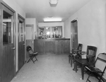 A waiting area in an office hallway by W. D. Smith