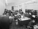 An office crowded with workers and filing cabinets by W. D. Smith