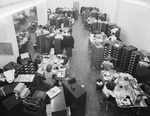 An office crowded with workers and filing cabinets by W. D. Smith