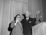 Unidentified man and Wingate Lucas standing by a podium by W. D. Smith