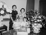 J. Lee Johnson Jr. sitting at his desk with family by W. D. Smith